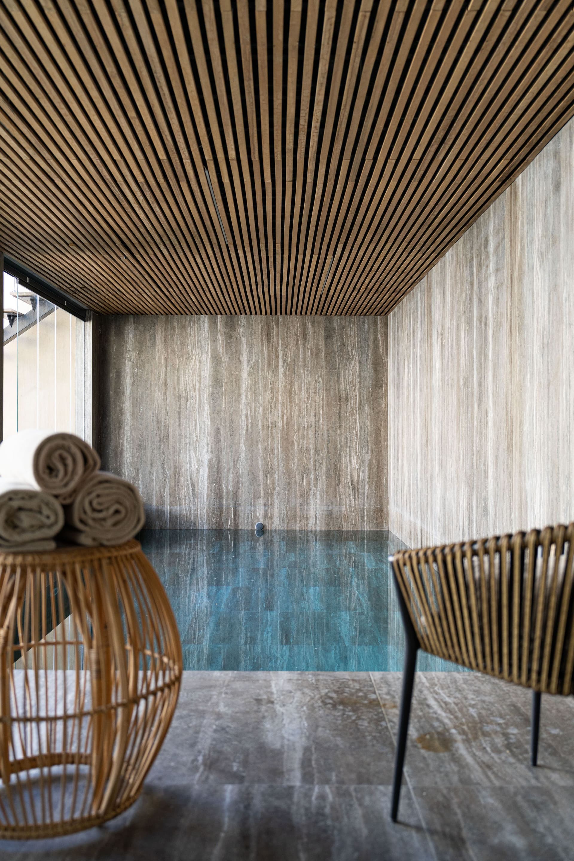 Piscine intérieure moderne avec plafond en bois.