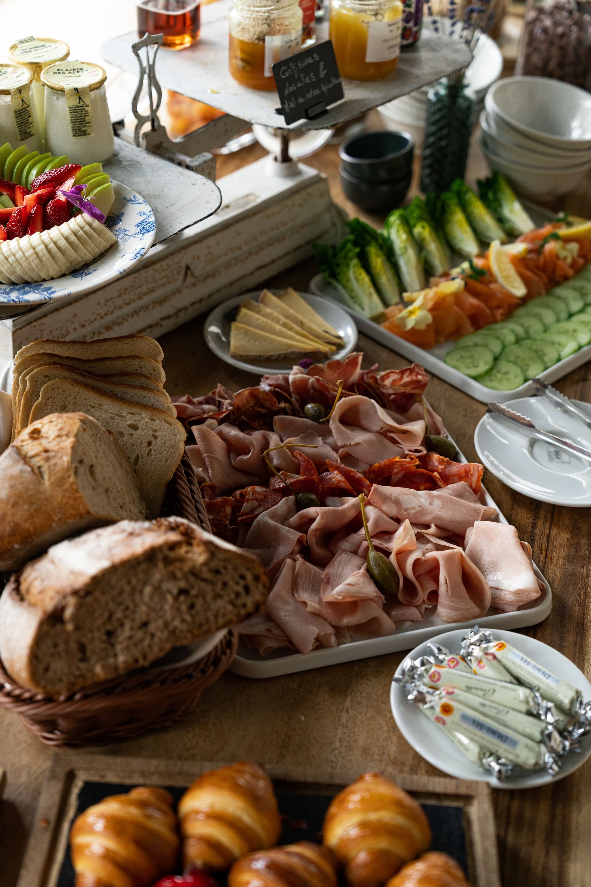 Buffet petit-déjeuner avec fruits et charcuterie.