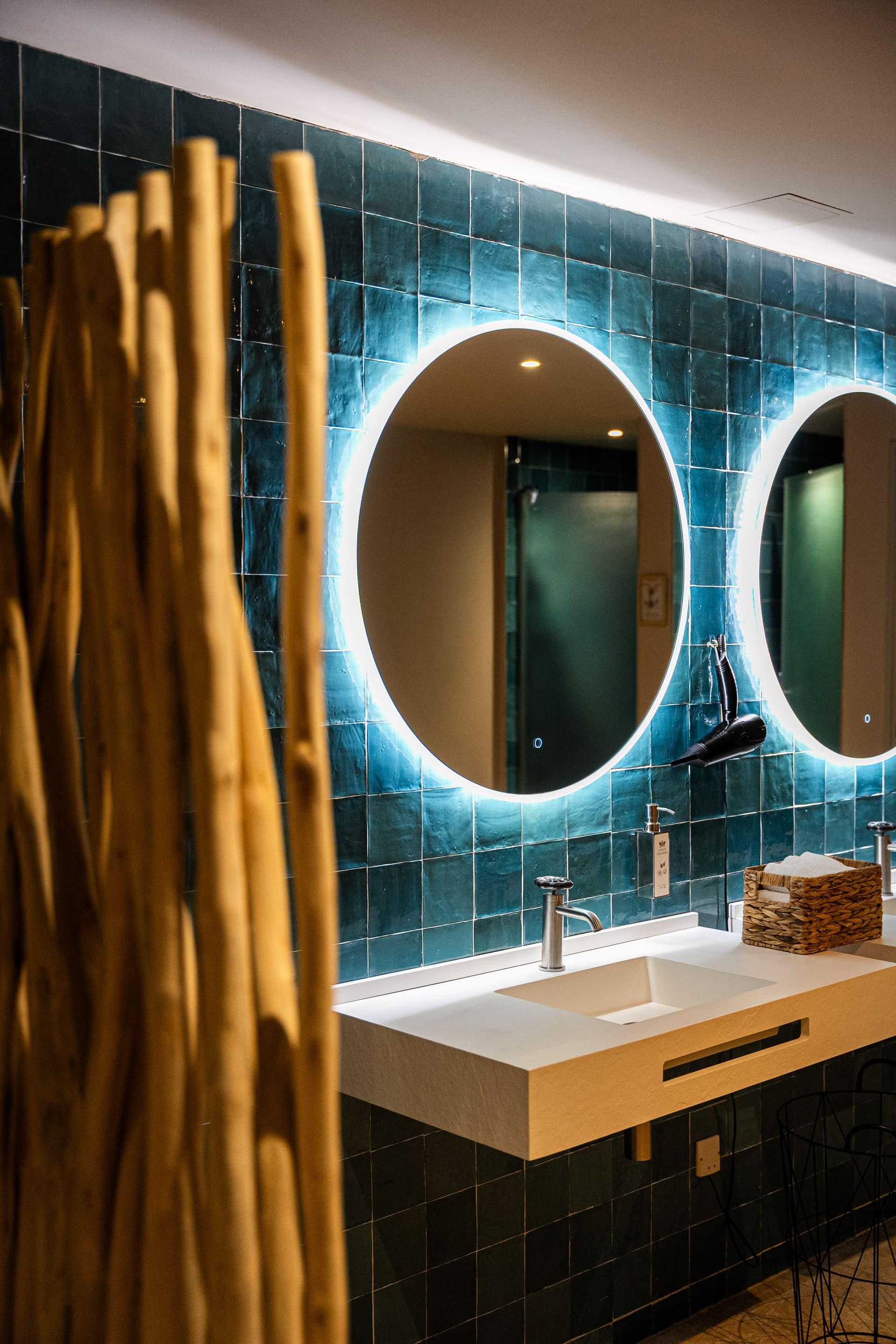 Salle de bain moderne avec miroir éclairé circulaire.